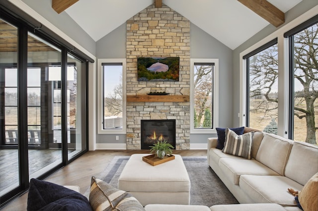 935 Lakewood Hills Rd, Eagan, MN 55123 - living room featuring beamed ceiling, wood finished floors, a stone fireplace, and high vaulted ceiling