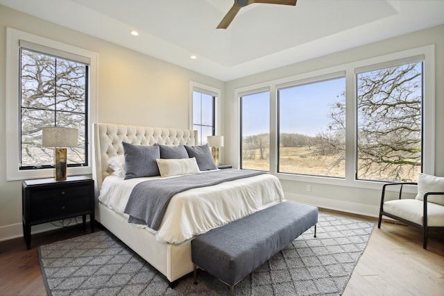 935 Lakewood Hills Rd, Eagan, MN 55123 - bedroom featuring baseboards, wood finished floors, recessed lighting, ceiling fan, and a tray ceiling