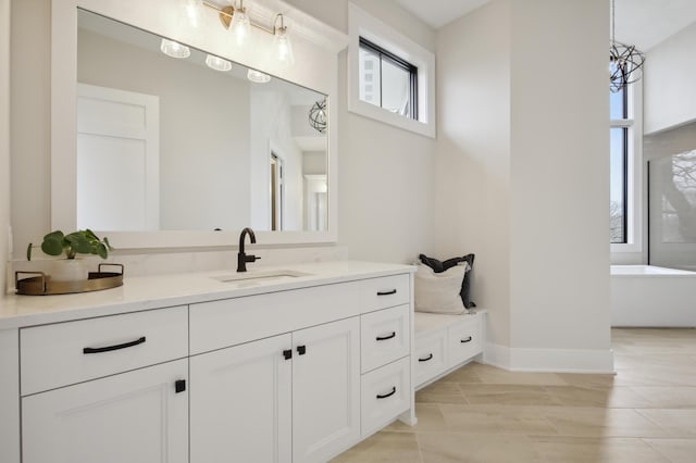 935 Lakewood Hills Rd, Eagan, MN 55123 - full bath featuring a soaking tub, vanity, and baseboards