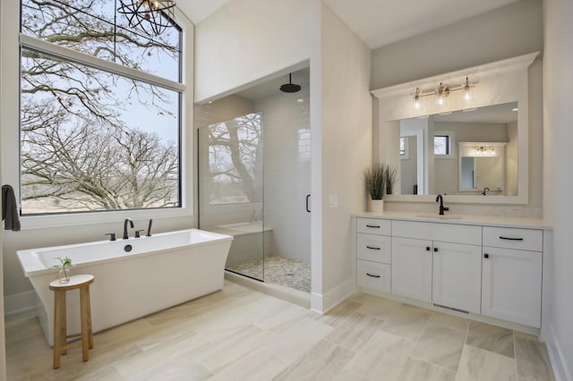 935 Lakewood Hills Rd, Eagan, MN 55123 - full bathroom featuring a shower stall, a soaking tub, vanity, and baseboards