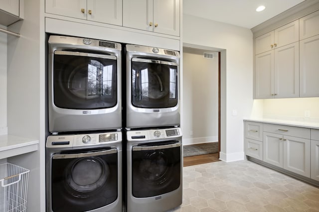 935 Lakewood Hills Rd, Eagan, MN 55123 - washroom with stacked washer / drying machine, cabinet space, light tile patterned floors, washer and dryer, and recessed lighting