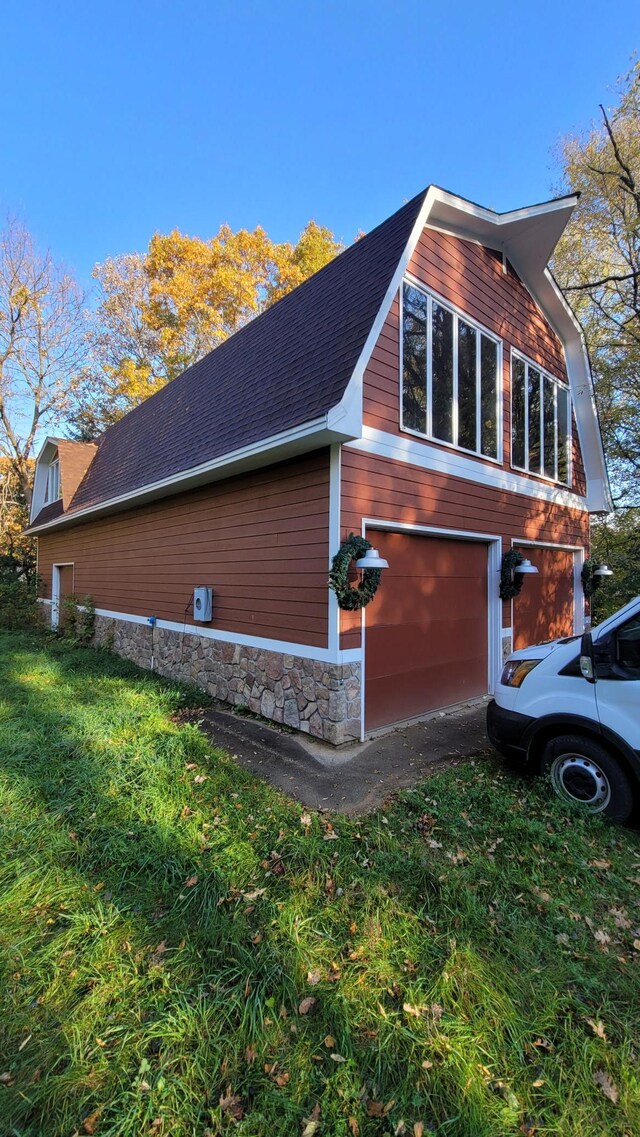 935 Lakewood Hills Rd, Eagan, MN 55123 - view of side of property featuring a shingled roof, stone siding, an attached garage, and a lawn