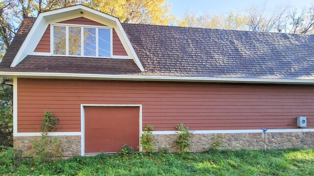 935 Lakewood Hills Rd, Eagan, MN 55123 - view of home's exterior featuring a garage, roof with shingles, and stone siding