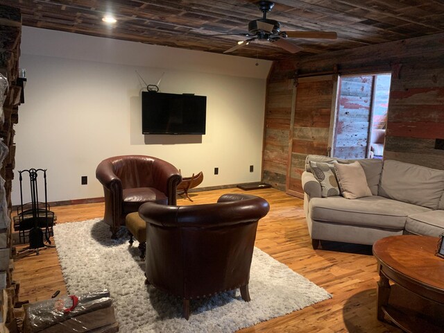 935 Lakewood Hills Rd, Eagan, MN 55123 - living room featuring baseboards, a ceiling fan, wood finished floors, and wooden walls
