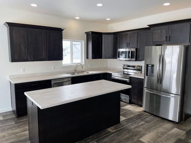 kitchen featuring a kitchen island, stainless steel appliances, dark hardwood / wood-style floors, and sink