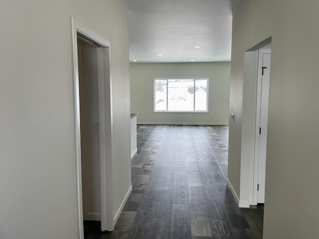 corridor with dark hardwood / wood-style flooring