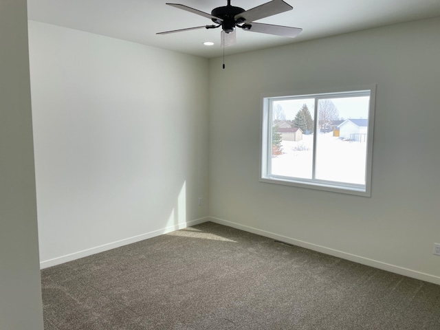 empty room featuring ceiling fan and carpet floors