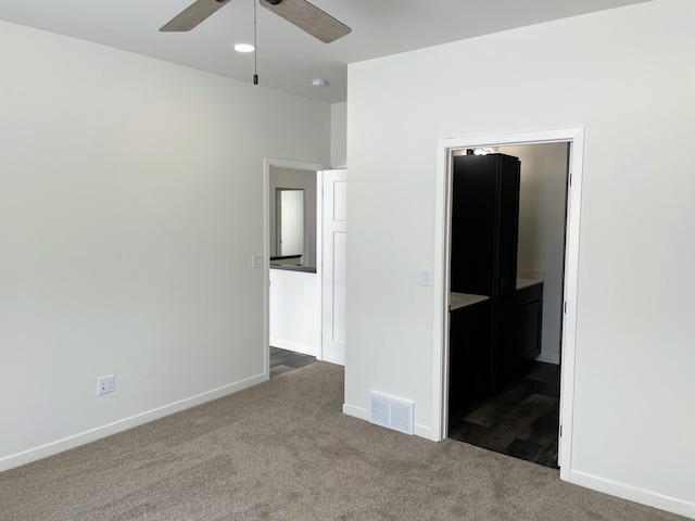 unfurnished bedroom featuring ceiling fan and dark colored carpet