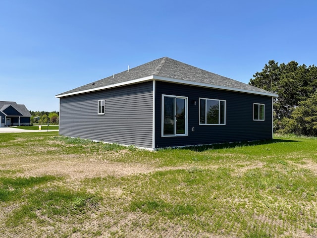 view of side of property with a yard