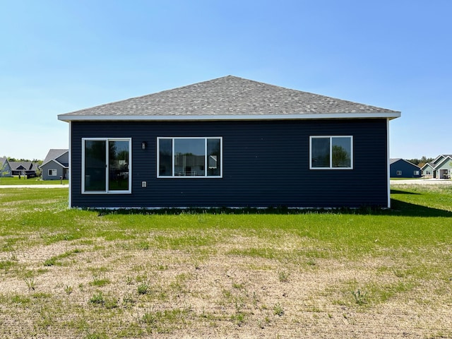 back of house featuring a yard