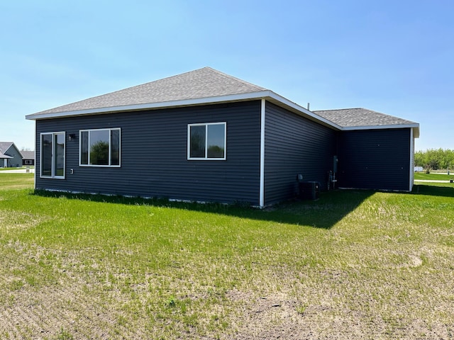 view of property exterior featuring a lawn and central air condition unit