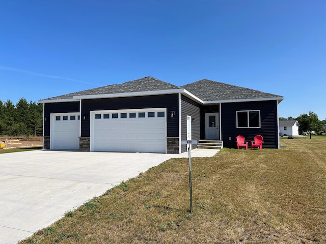 view of front of home with a front yard and a garage