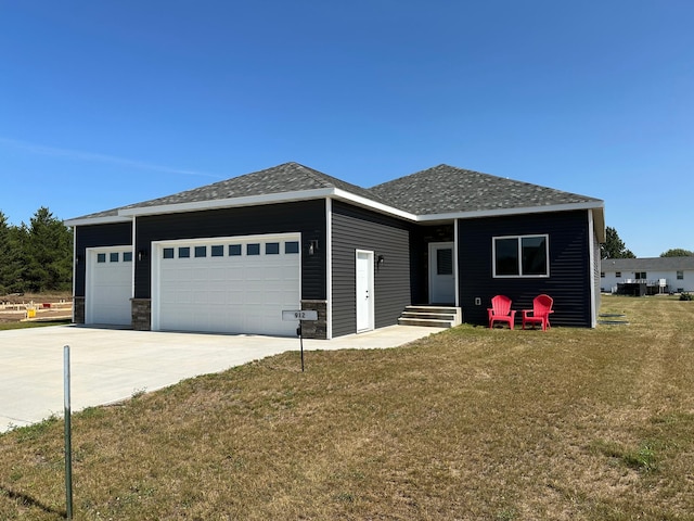 view of front of property with a front yard and a garage