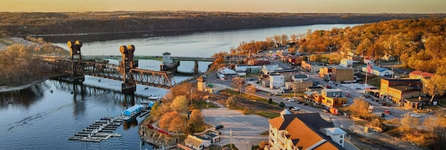 aerial view at dusk featuring a water view