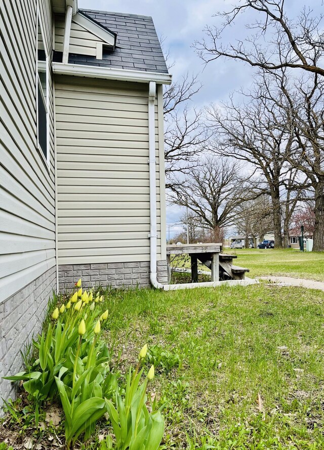 view of side of home featuring a yard