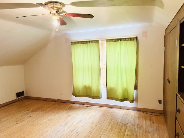 additional living space with light wood-type flooring, ceiling fan, and lofted ceiling