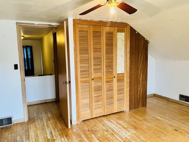 interior space with light hardwood / wood-style floors and vaulted ceiling