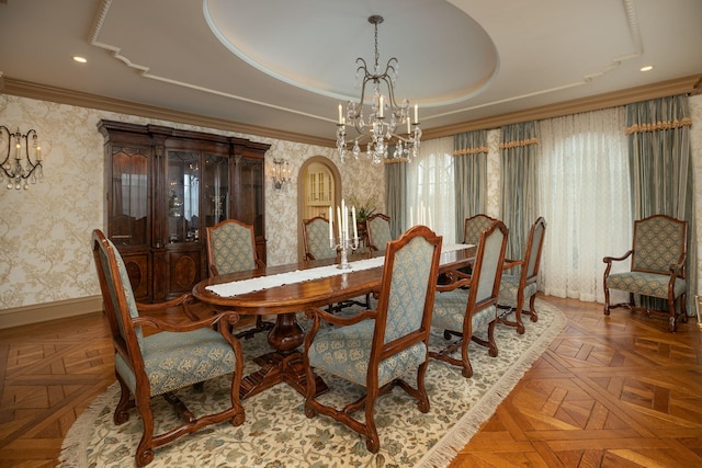 dining area with a chandelier, a raised ceiling, and dark parquet floors