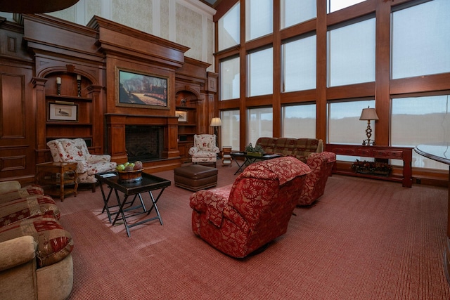 carpeted living room featuring a high ceiling