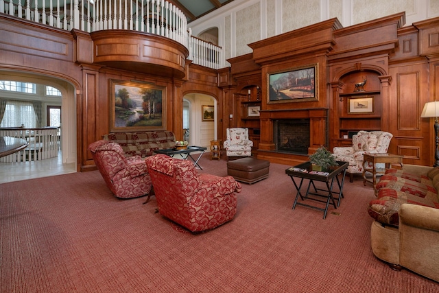 living room featuring wood walls and a high ceiling