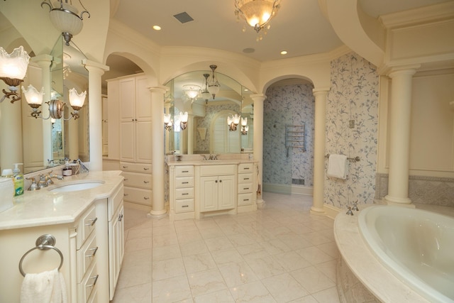 bathroom featuring an inviting chandelier, large vanity, ornamental molding, and ornate columns