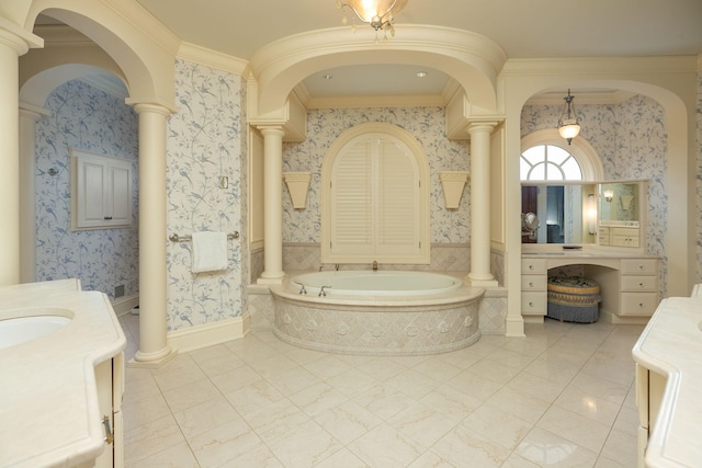 bathroom with a tub, crown molding, decorative columns, and vanity