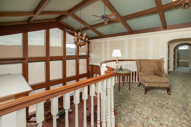 hall featuring carpet flooring, vaulted ceiling with beams, and a chandelier