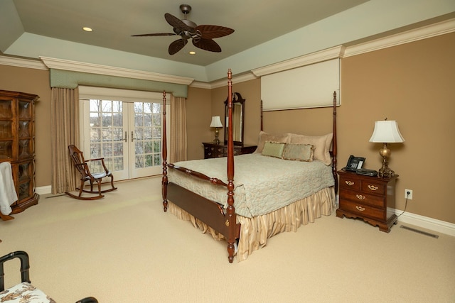 bedroom featuring a raised ceiling, ceiling fan, carpet, and french doors