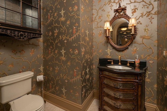 bathroom featuring vanity, tile flooring, and toilet