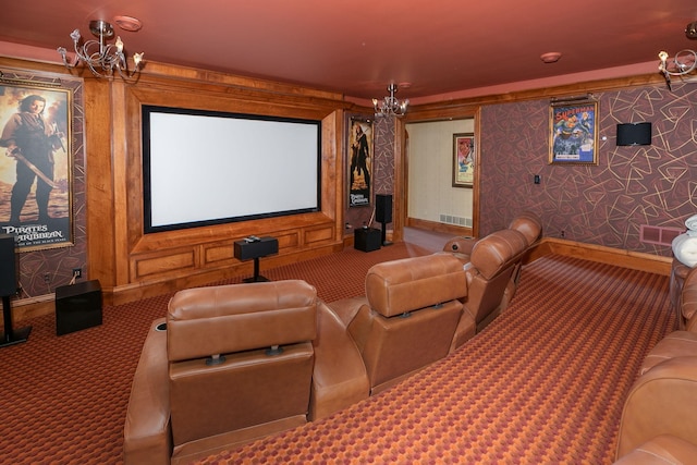 home theater room featuring a chandelier and carpet