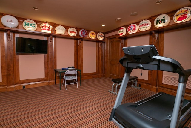 exercise area featuring dark carpet