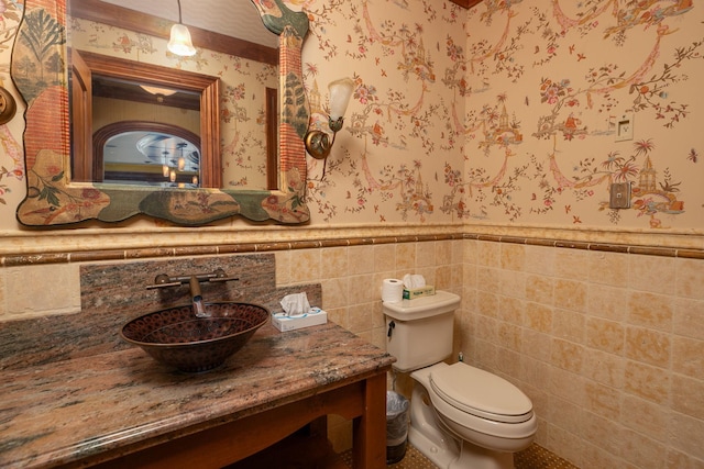 bathroom featuring vanity, backsplash, toilet, and tile walls