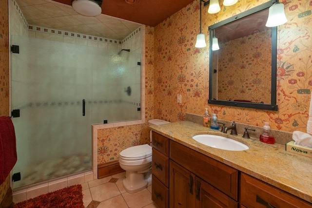 bathroom with toilet, a shower with door, tile flooring, and vanity