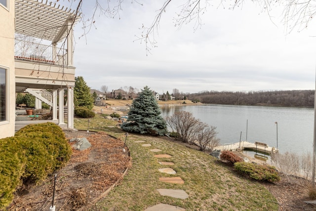 view of yard with a water view and a boat dock