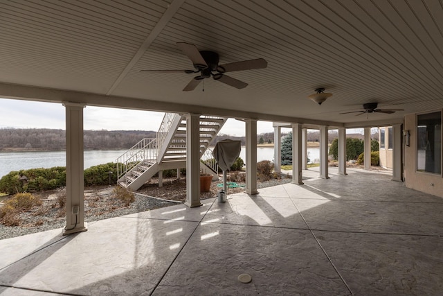 view of patio / terrace featuring ceiling fan and a water view