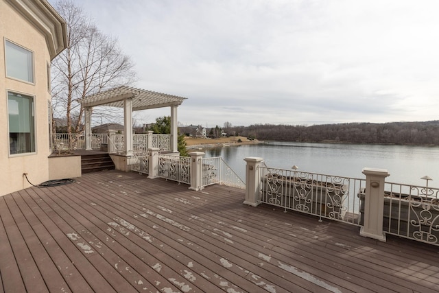 deck featuring a gazebo, a pergola, and a water view