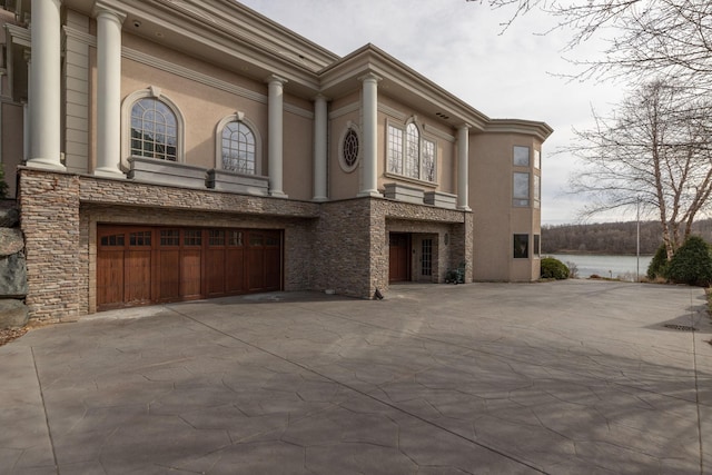 view of front of house featuring a water view and a garage