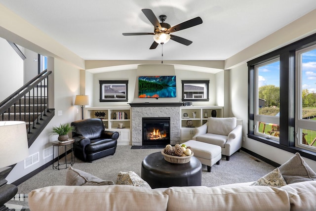 carpeted living room featuring built in features, lofted ceiling, and ceiling fan