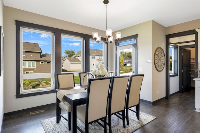 dining area featuring a chandelier and dark hardwood / wood-style floors