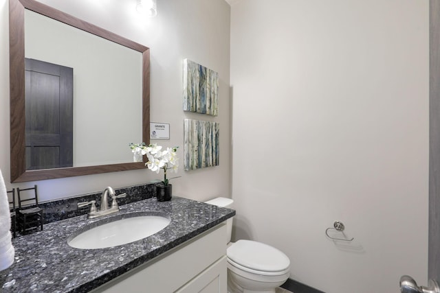 bathroom featuring toilet and vanity with extensive cabinet space