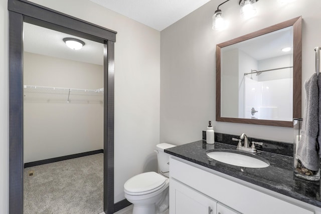 bathroom with toilet and large vanity