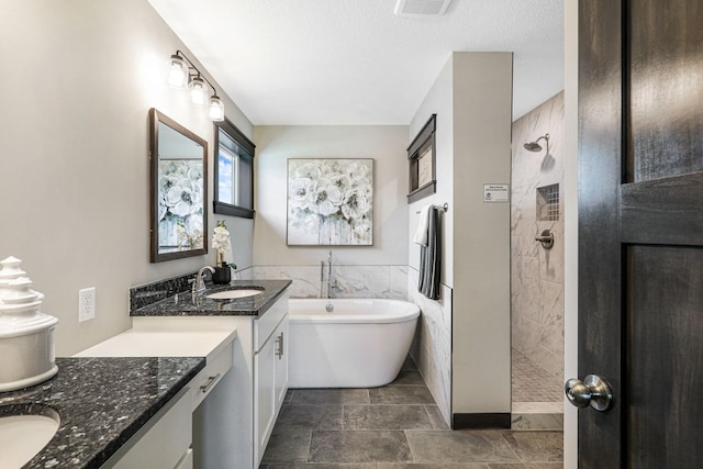 bathroom with a textured ceiling, vanity, tile flooring, and independent shower and bath