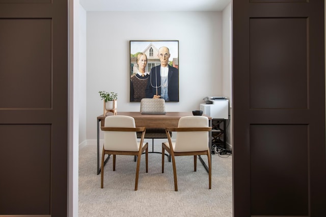 dining area featuring light colored carpet