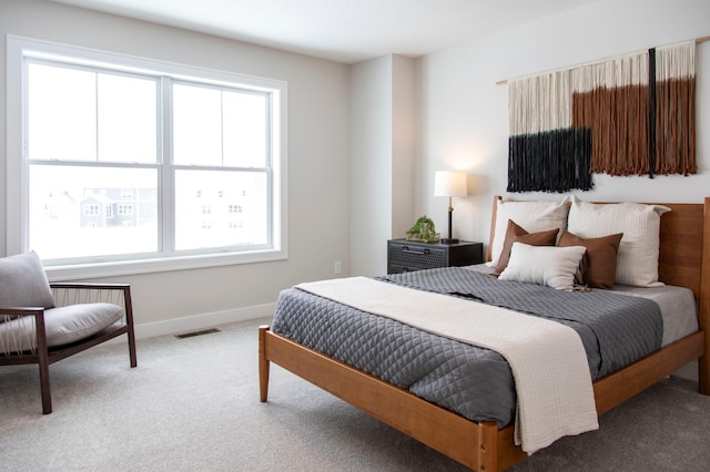 bedroom with multiple windows and carpet flooring