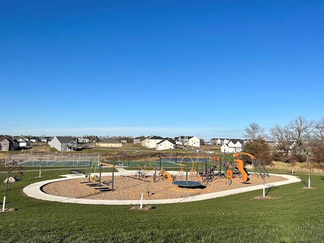 community jungle gym featuring a residential view and a yard