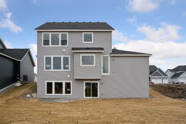 back of property with cooling unit, a yard, and a patio