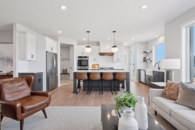 living area featuring light wood-style flooring and recessed lighting