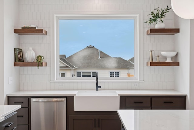 kitchen with a sink, dark brown cabinets, open shelves, and stainless steel dishwasher