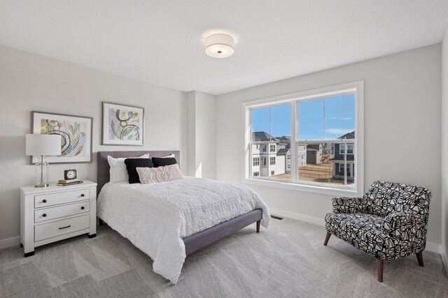 bedroom with carpet floors, visible vents, and baseboards