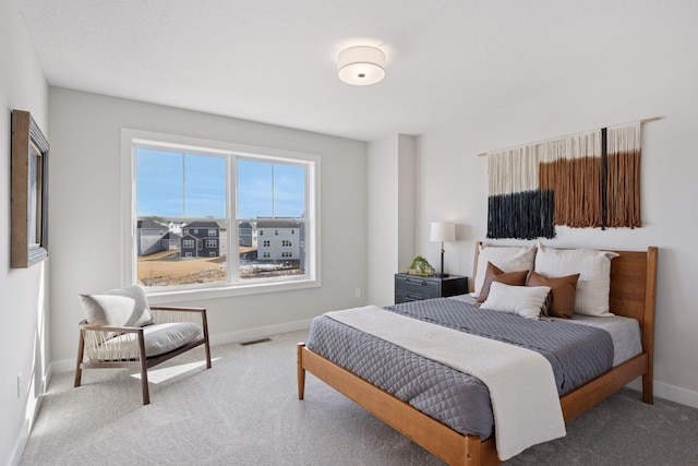 bedroom featuring carpet floors, visible vents, and baseboards